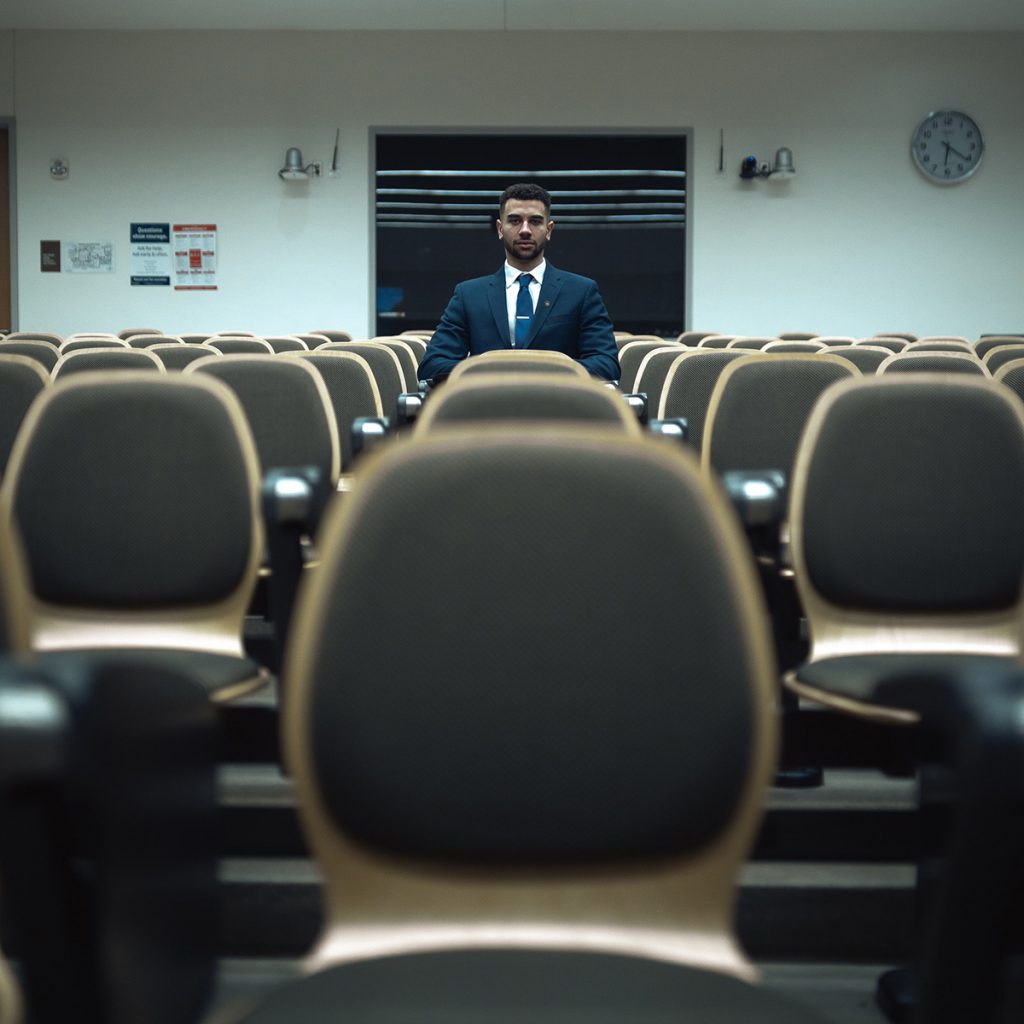 man sitting alone in a seminar room